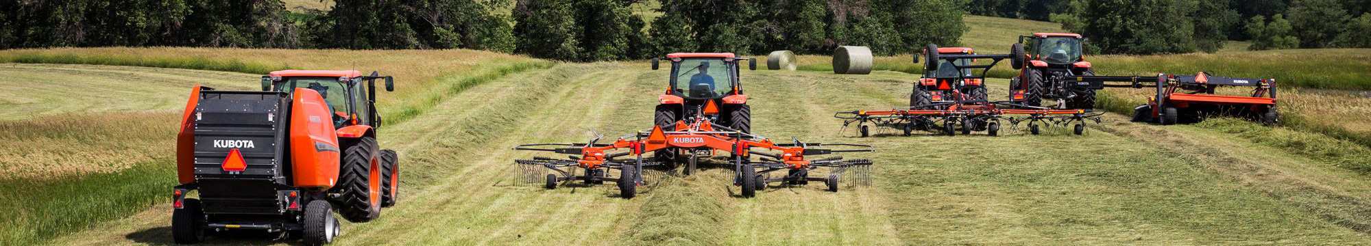 tractor and sprayer spraying wheat
